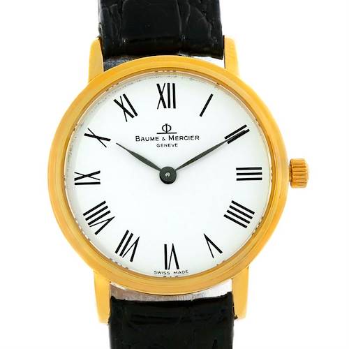 The Baume & Mercier MV045089 Women's Yellow Gold White Dial MV045089 Women's Yellow Gold White Dial Classima Ladies MV045089 watch is shown from the front, displaying its face, Roman numerals, bezel, and a portion of the leather strap.