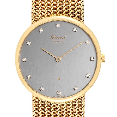 The image shows a close-up of the face and bezel of the Chopard Classique 1091 Men's Yellow Gold Grey Dial 1091 Men's Yellow Gold Grey Dial watch, highlighting its gold finish and mesh band.