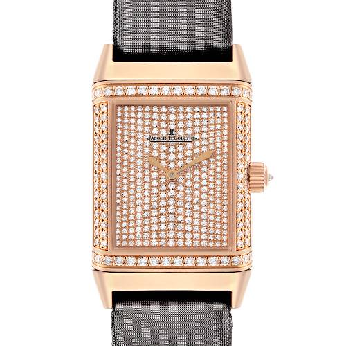 The Jaeger-LeCoultre Reverso watch is shown front-on, displaying its diamond-studded face and crown with a strap section.