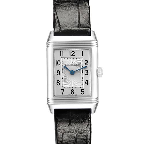 The Jaeger-LeCoultre Reverso watch is shown from the front, displaying its rectangular dial and leather strap.
