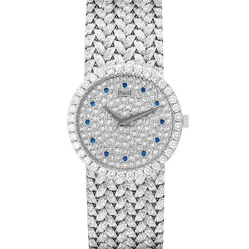 The Piaget 9706D2 Women's White Gold Silver Dial 9706D2 Women's White Gold Silver Dial Tradition 9706D2 watch is shown in a top-down view, displaying the diamond and sapphire-encrusted dial and bracelet.