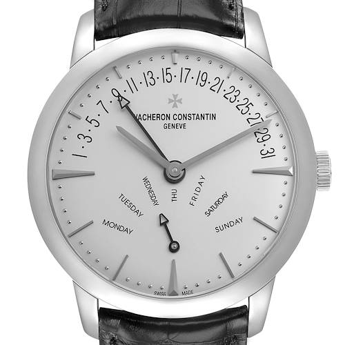 The Vacheron Constantin Patrimony 86020 Men's White Gold Silver Dial watch is shown from a front angle, displaying the dial, hands, and day and date indicators.